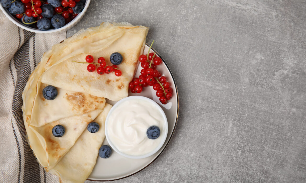 Delicious crepes with natural yogurt, blueberries and red curran